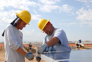 Construction workers setting up solar panels